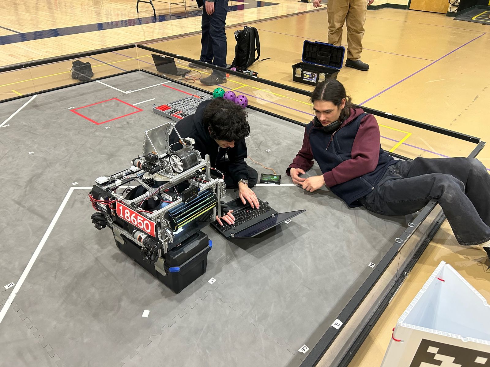 Students working on robot at the field